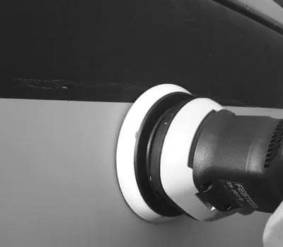 Sanding gelcoat with minor scratches to prepare for polishing.