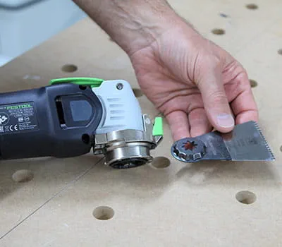 Shorten a door frame and lay laminate under the door frame