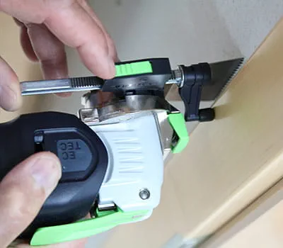 Shorten a door frame and lay laminate under the door frame