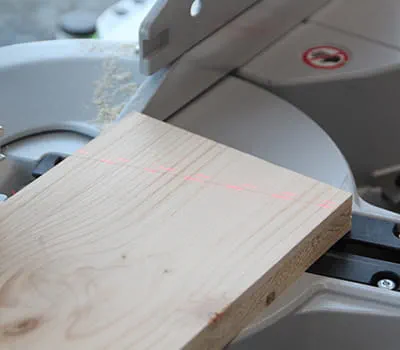 Cutting the wooden butt straps with the compound mitre saw