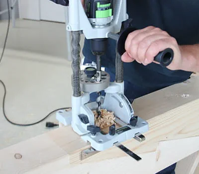 Use the drill stand to make a bore hole for the screw-bolt-joint