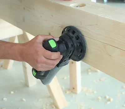 Sanding machining areas with a cordless sander