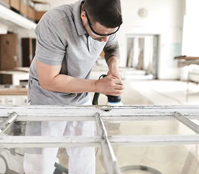 Removing old paint from the damaged area