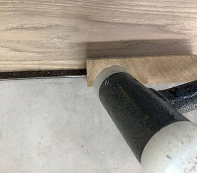 Tapping down with a hammer