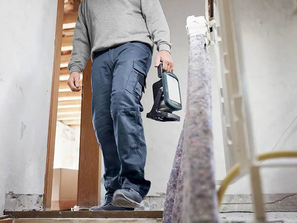 A craftsman carries a Working light